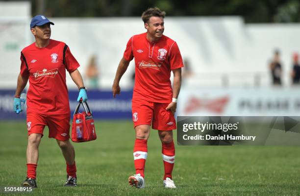 Graeme LeSaux of Wembley FC leaves the pitch with an injury during a Budweiser FA Cup Extra Preliminary Round at Vale Farm Stadium, on August 11,...
