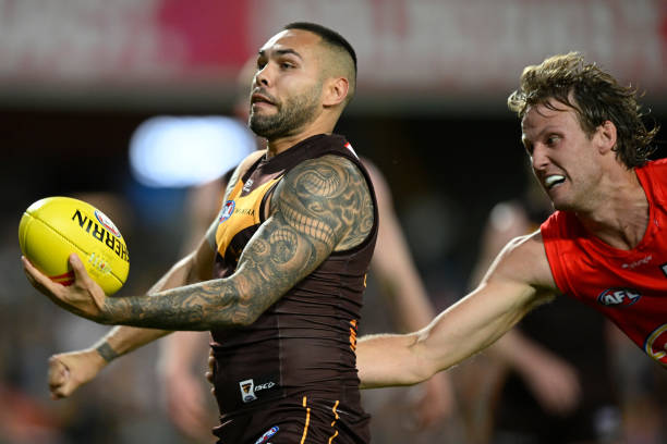 Jarman Impey of the Hawks handballs during the round 15 AFL match between Gold Coast Suns and Hawthorn Hawks at Heritage Bank Stadium, on June 25 in...