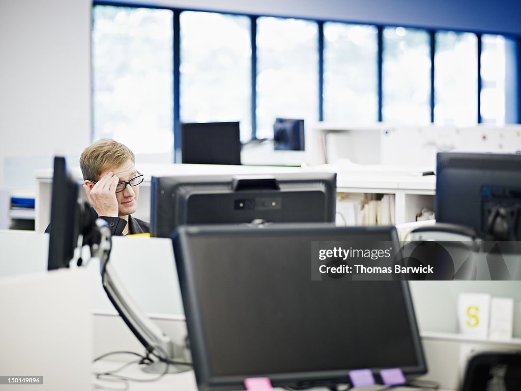 Businessman in office looking at computer monitor