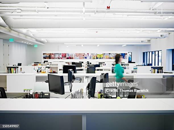 businesswoman walking through empty office - the bigger picture stock pictures, royalty-free photos & images