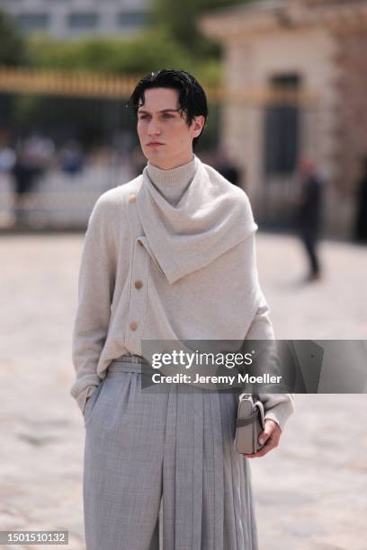 Chase Hudson is seen wearing a beige sweater jacket, grey suit pants and beige rubber boots outside Dior Homme during the Menswear Spring/Summer 2024...