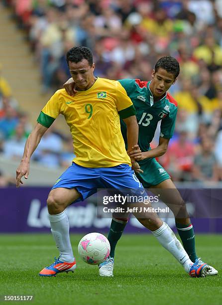 Leandro Damiao of Brazil battles for the ball with Diego Reyes of Mexico during the Men's Football Final between Brazil and Mexico on Day 15 of the...