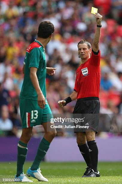 Referee Mark Clattenburg shows a yellow card to Diego Reyes of Mexico during the Men's Football Final between Brazil and Mexico on Day 15 of the...