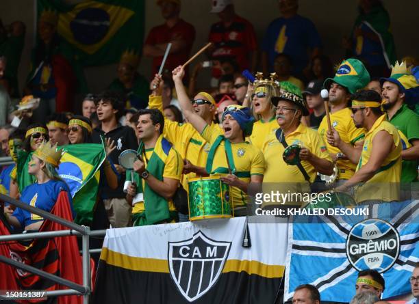 Brazil's supporters cheer their team during the men's football final match between Brazil and Mexico at Wembley stadium during the London 2012...
