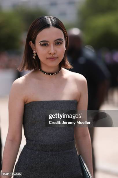 Lala Takahashi is seen wearing a grey corset, grey midi skirt, black leather bag and black leather boots outside Dior Homme during the Menswear...