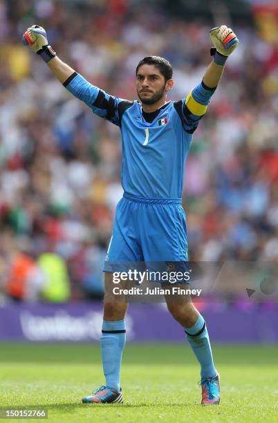 Jose Corona of Mexico celebrates as team-mate Oribe Peralta of Mexico scores their second goal during the Men's Football Final between Brazil and...