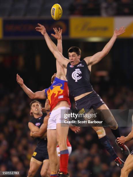 Matthew Kreuzer of the Blues and Ben Hudson of the Lions compete for the ball during the round 20 AFL match between the Carlton Blues and the...