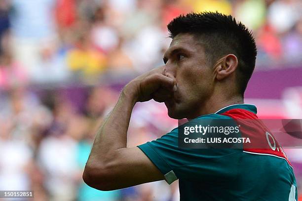 Mexico's forward Oribe Peralta celebrates after he scored his team's second goal in the men's football final match between Brazil and Mexico at...