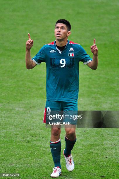 Mexico's forward Oribe Peralta celebrates after he scored his team's second goal in the men's football final match between Brazil and Mexico at...
