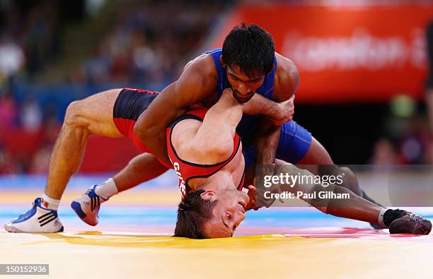 Yogeshwar Dutt of India in action against Anatolie Ilarionovitch Gudea of Bulgaria in the Men's Freestyle Wrestling 60kg qualification match on Day...