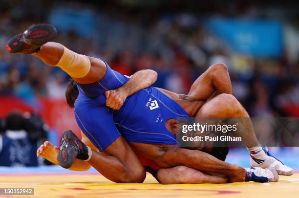 Yogeshwar Dutt of India in action against Anatolie Ilarionovitch Gudea of Bulgaria in the Men's Freestyle Wrestling 60kg qualification match on Day...