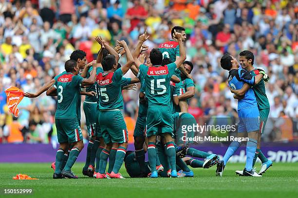Mexico players celebrate winning the goal medal after victory in the Men's Football Final between Brazil and Mexico on Day 15 of the London 2012...