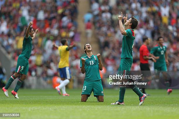Diego Reyes of Mexico falls to his knees and celebrates winning the goal medal after victory in the Men's Football Final between Brazil and Mexico on...