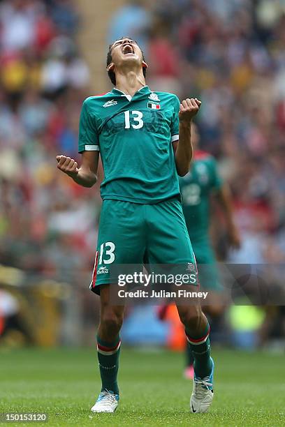 Diego Reyes of Mexico celebrates winning the goal medal after victory in the Men's Football Final between Brazil and Mexico on Day 15 of the London...