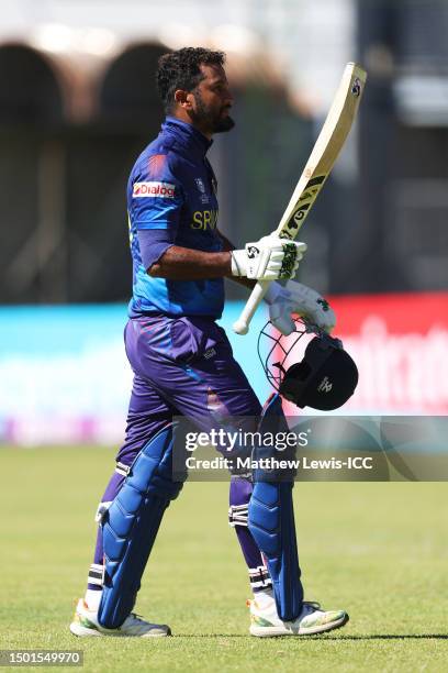 Dimuth Karunarathana of Sri Lanka raises his bat while leaving the field after being bowled by Mark Adair of Ireland during the ICC Men's Cricket...