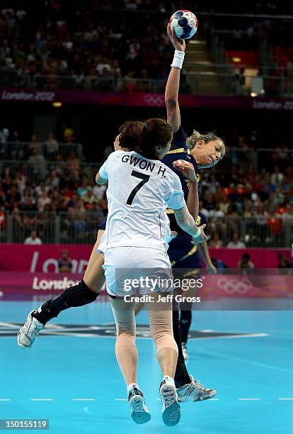 Begona Fernandez Molinos of Spain scores against Han Na Gwon of South Korea during the Women's Handball Bronze Medal Match on Day 15 of the London...