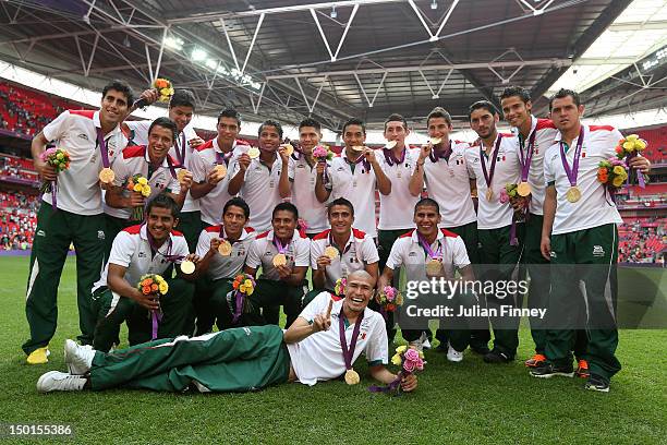 Gold medal winners Mexico pose with their medals after the medal ceremony for the Men's Football Final between Brazil and Mexico on Day 15 of the...