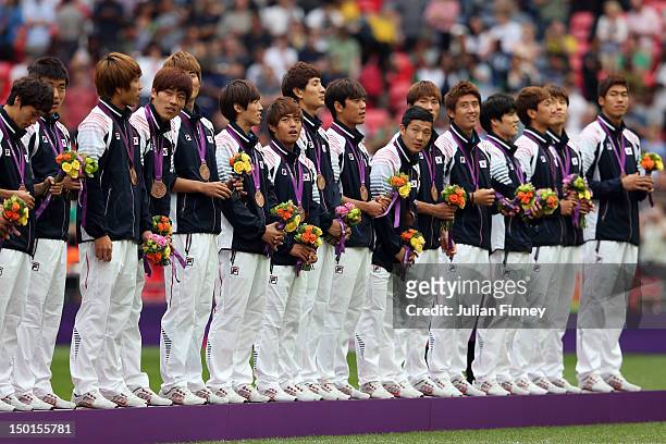 Bronze medallists Korea celebrate during the medal ceremony for the Men's Football Final between Brazil and Mexico on Day 15 of the London 2012...