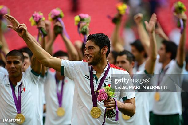 Mexico's goalkeeper Jose Corona poses with his gold medal during the podium ceremony after the football match against Mexico at the London Olympic...