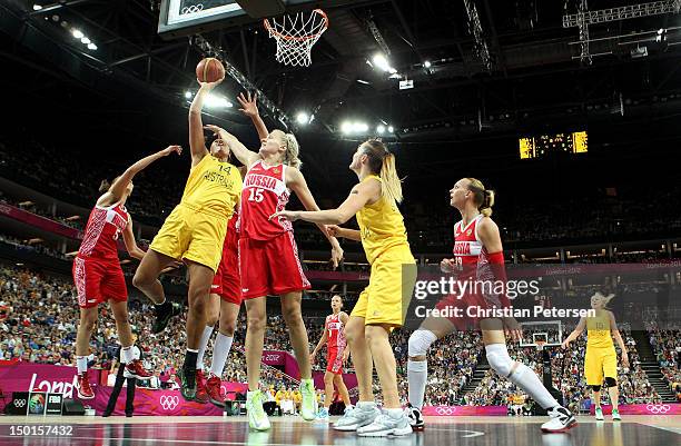 Liz Cambage of Australia attempts a shot against Nadezhda Grishaeva and Evgeniya Belyakova of Russia during the Women's Basketball Bronze Medal game...