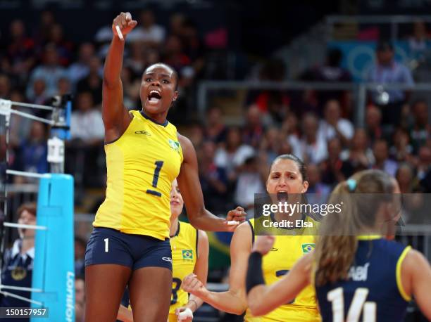 Fabiana Claudino reacys after blocking a shot againt United States as Danielle Lins looks on during the Women's Volleyball gold medal match on Day 15...