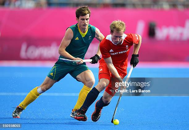 Fergus Kavanagh of Australia chases Barry Middleton of Great Britain during the Men's Hockey bronze medal match on Day 15 of the London 2012 Olympic...