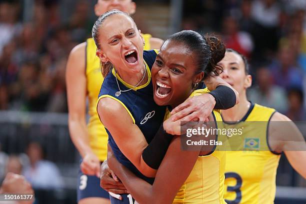 Fabiana Oliveira and Fabiana Claudino of Brazil react after a point against United States during the Women's Volleyball gold medal match on Day 15 of...