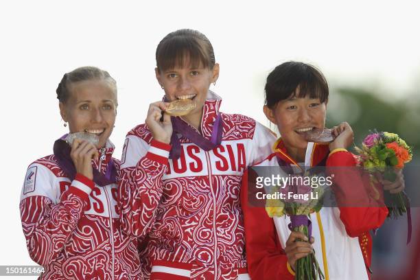 Gold medalist Elena Lashmanova of Russia, silver medalist Olga Kaniskina of Russia and bronze medalist Shenjie Qieyang of China attend the medal...