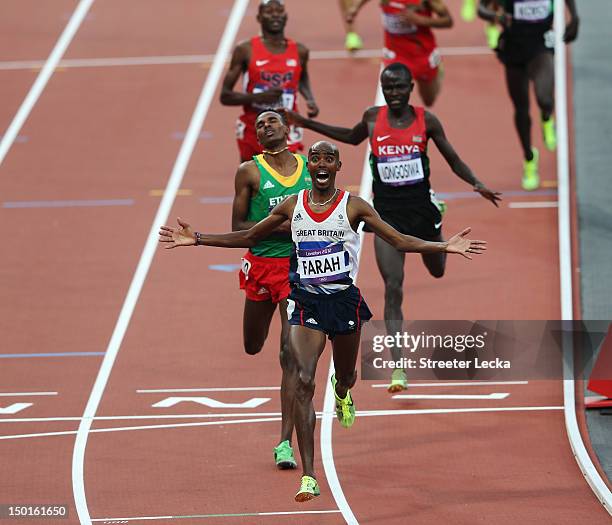 Mohamed Farah of Great Britain crosses the finish line to win gold ahead of Dejen Gebremeskel of Ethiopia and Thomas Pkemei Longosiwa of Kenya in the...