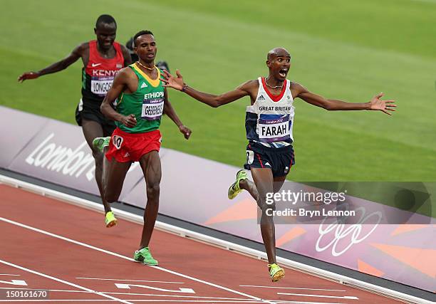 Mohamed Farah of Great Britain celebrates as he crosses the finish line to win gold ahead of Dejen Gebremeskel of Ethiopia and Thomas Pkemei...