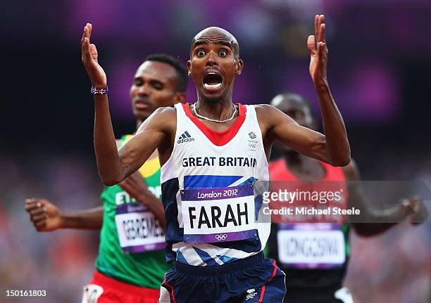 Mohamed Farah of Great Britain celebrates as he crosses the finish line to win gold ahead of Dejen Gebremeskel of Ethiopia and Thomas Pkemei...