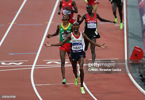 Mohamed Farah of Great Britain crosses the finish line to win gold ahead of Dejen Gebremeskel of Ethiopia and Thomas Pkemei Longosiwa of Kenya in the...