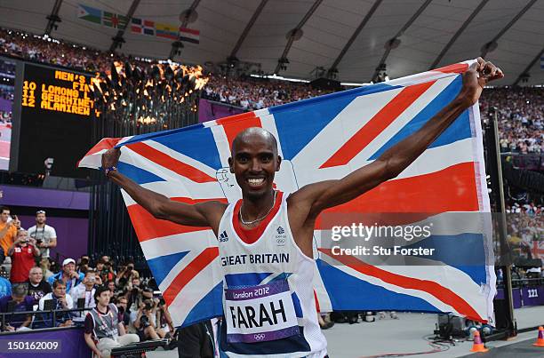 Mohamed Farah of Great Britain holds a union jack aloft as he celebrates winning gold in the Men's 5000m Final on Day 15 of the London 2012 Olympic...