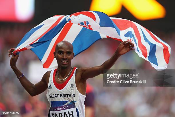 Mohamed Farah of Great Britain holds a union jack aloft as he celebrates winning gold in the Men's 5000m Final on Day 15 of the London 2012 Olympic...