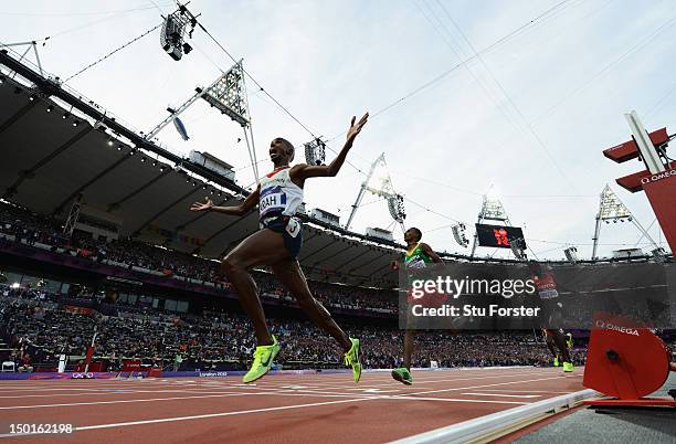 Mohamed Farah of Great Britain crosses the finish line to win gold ahead of Dejen Gebremeskel of Ethiopia and Thomas Pkemei Longosiwa of Kenya in the...