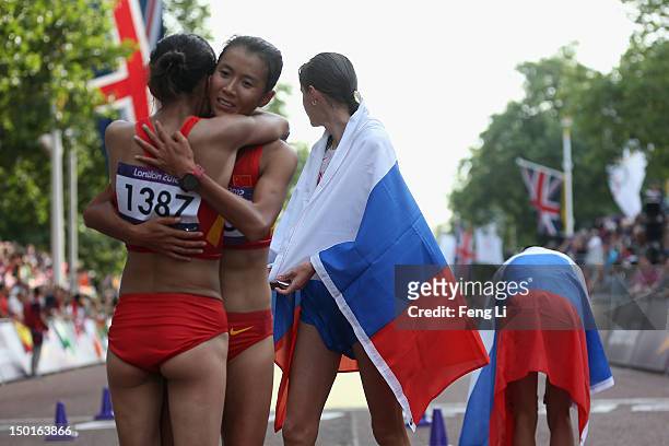 Shenjie Qieyang celebrates her bronze with Liu Hong of China after the Women's 20km Walk on Day 15 of the London 2012 Olympic Games on the streets of...
