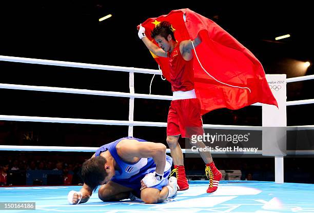 Shiming Zou of China celebrates his victory as Kaeo Pongprayoon of Thailand reacts after the Men's Light Fly Boxing final bout on Day 15 of the...