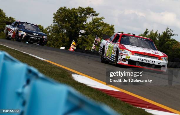 Tim Connolly, driver of the Michael Connolly Endowment for Lung Cancer Chevrolet, leads Dexter Stacey, driver of the R3 Motorsports Chevrolet, during...