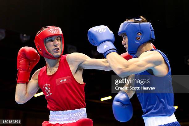 John Joe Nevin of Ireland throws a punch against Luke Campbell of Great Britain during the Men's Bantam Boxing final bout on Day 15 of the London...