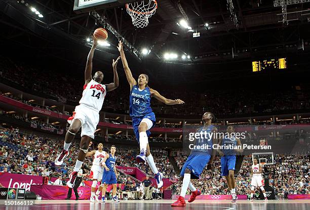 Tina Charles of United States goes up for a layup against Emmeline Ndongue of France in the first half during the Women's Basketball Gold Medal game...