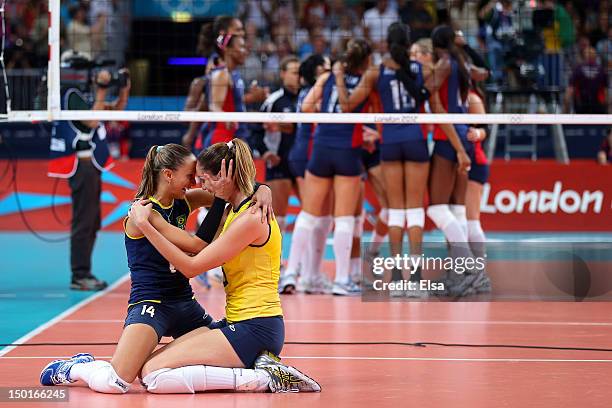 Fabiana Oliveira and Thaisa Menezes of Brazil of Brazil reacts after defeating the United States to win the Women's Volleyball gold medal match on...
