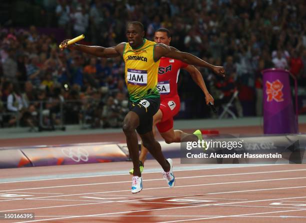 Usain Bolt of Jamaica crosss the finish line ahead of Ryan Bailey of the United States to win gold and set a new world record of 36.84 during the...