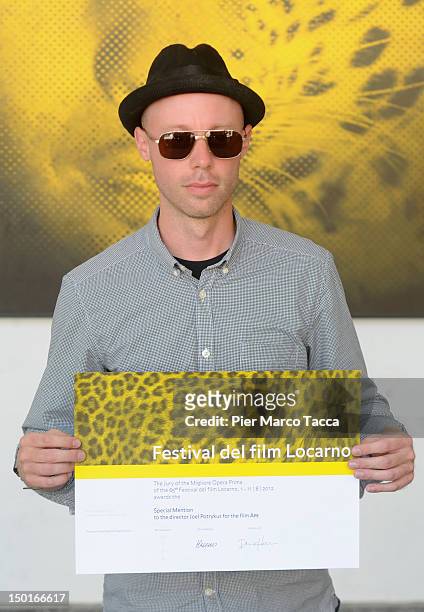 DirectorJoel Potrykus poses with the Best First Feature award during the 65th Locarno Film Festival on August 11, 2012 in Locarno, Switzerland.