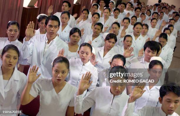 Filipino nurses attend the mass oath taking ceremony for nurses who passed the scandal tainted June 2006 nursing licensure examination at the...