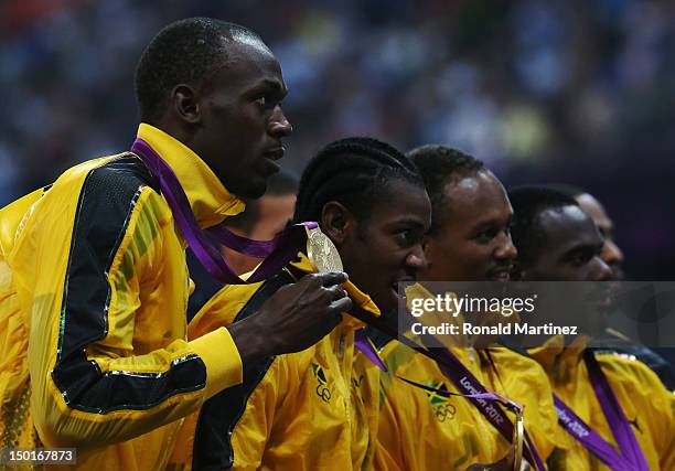 Gold medalists Nesta Carter, Michael Frater, Usain Bolt and Yohan Blake of Jamaica pose on the podium during the medal ceremony for the Men's 4 x...