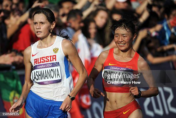 Elena Lashmanova of Russia races to a gold medal in front of Shenjie Qieyang of China who took bronze during the Women's 20km Walk final on Day 15 of...