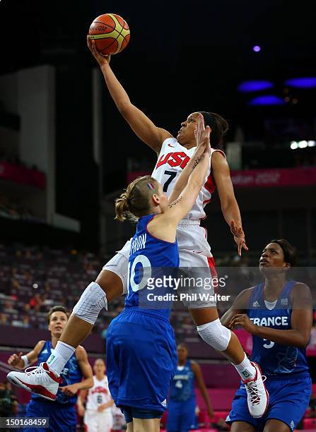 Maya Moore of United States goes up for a shot against Florence Lepron of France in the second half during the Women's Basketball Gold Medal game on...