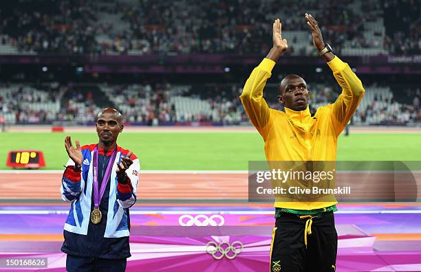 Gold medalists Mohamed Farah of Great Britain and Usain Bolt of Jamaica applaud the supporters on Day 15 of the London 2012 Olympic Games at Olympic...