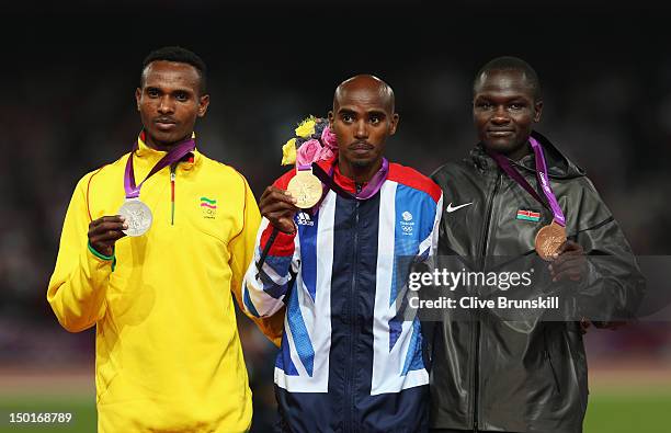 Gold medalist Mohamed Farah of Great Britain, silver medalist Dejen Gebremeskel of Ethiopia and bronze medalist Thomas Pkemei Longosiwa of Kenya pose...