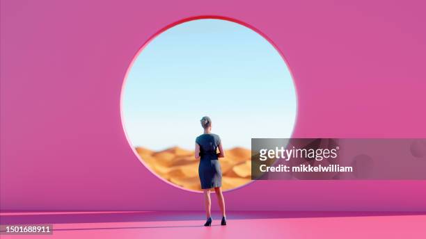 woman finds peace standing before pink wall while gazing into desert - landscape no people concept stock pictures, royalty-free photos & images